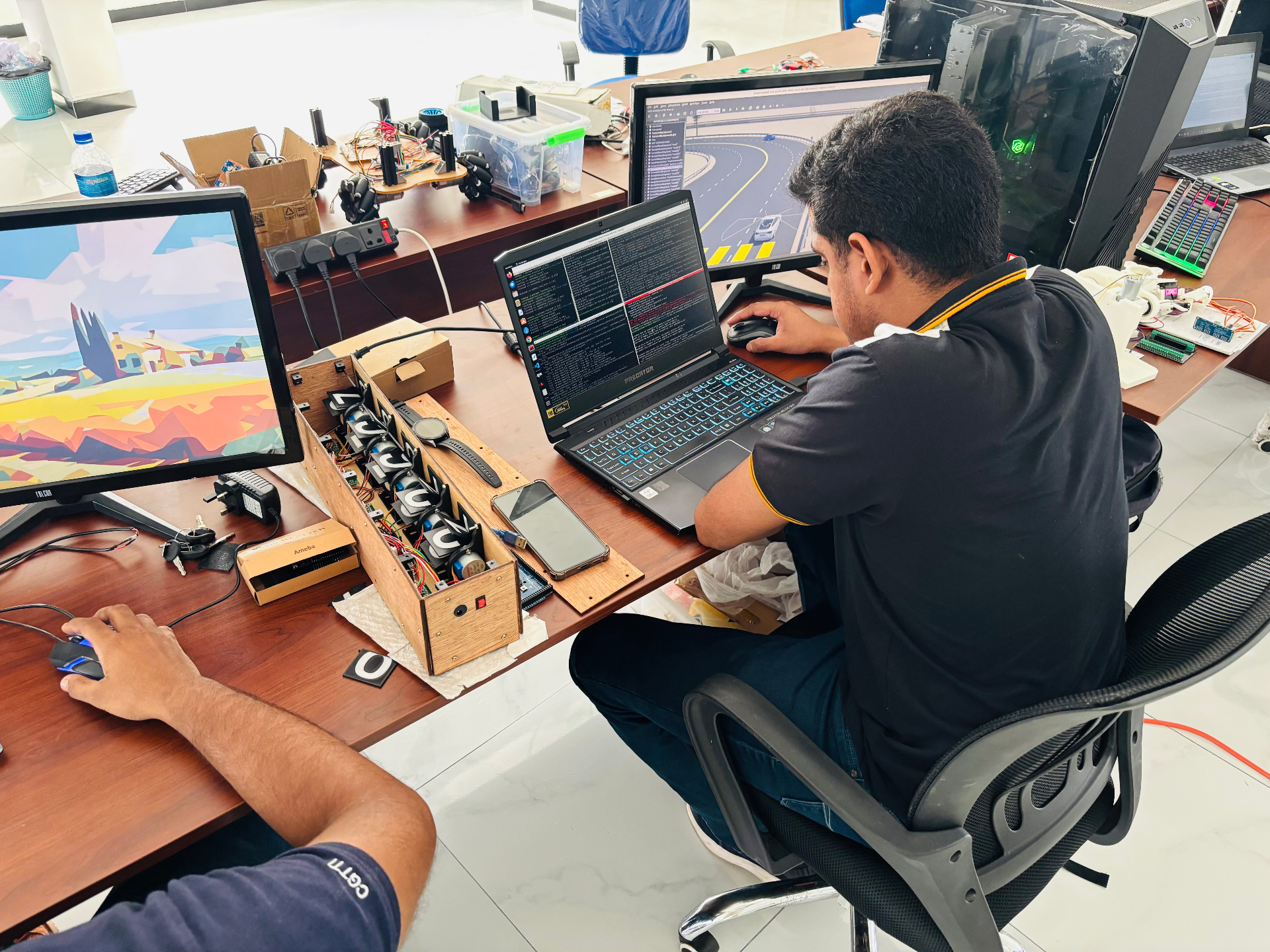 Robotics engineer testing motor-control hardware at the Idea8 lab